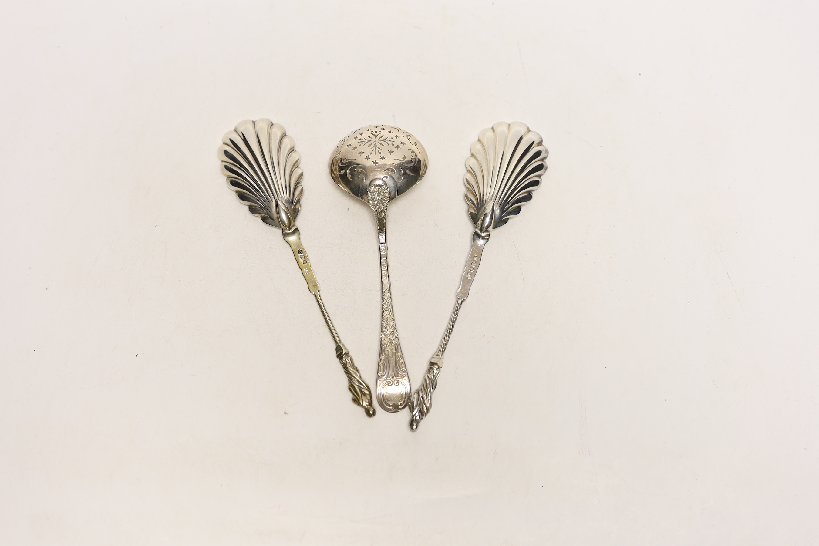 A pair of Victorian silver apostle serving spoons, Edward Hutton, London, 1890, 20.5cm and a George III silver sifter spoon, London, 1761.